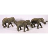 Pair of Indian bronze elephants with decorative caparison, each holding a flower in its trunk, and