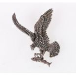 Sterling silver marcasite and ruby set brooch modelled as an eagle catching a salmon, 7cm tall