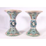 Pair of Japanese Kutani vases with flaring neck and foot and faceted waist, decorated with