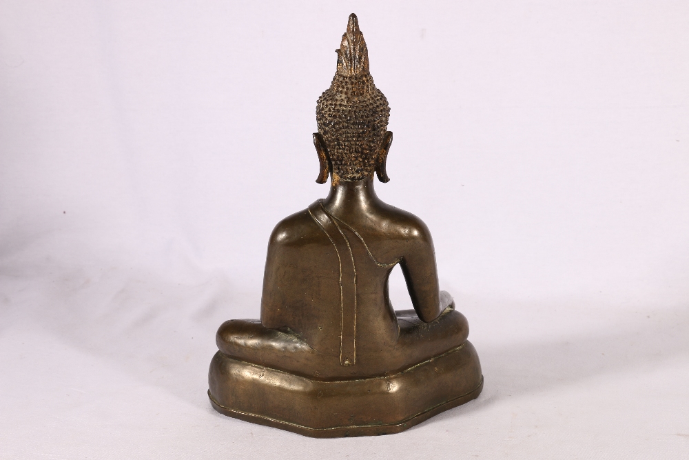 A 19th Century bronze buddha with flaming usnisa on domed base, traces of gilding possibly Thai, - Image 2 of 3