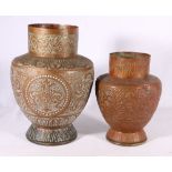 Two middle Eastern copper vases with scrolling foliate repousse decoration, 23.5 cm & 31 cm.