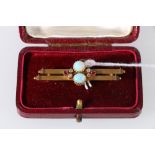 15ct gold bar brooch set two opals, four diamonds and two rubies. 3.6g