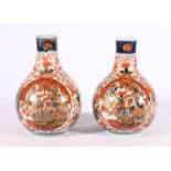 Pair of 19th Century Chinese clobbered vases in the Imari style of bulbous pear shape with floral