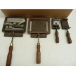 Book Binding Equipment.  Four metal letterpress printing chase type holders with turned wooden