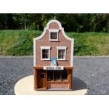 Dolls house. In the form of a country store, contains various contents, 68cm high x 38cm long