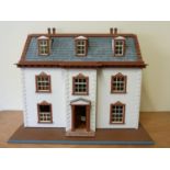 Dolls house. In the Georgian style, white & terracotta finish, includes various contents, tile