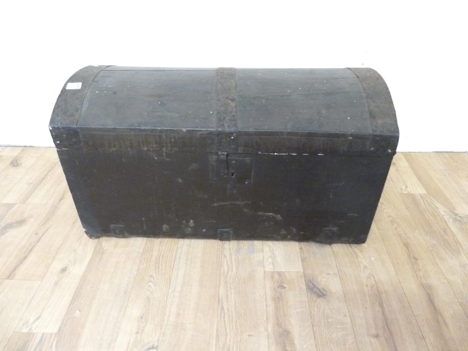 Antique black painted dome top trunk with metal banding and carrying handles, 27cm wide.