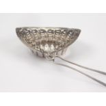 UnusualÂ silver tea strainer of boat shape, with prongs to engage the sprout, by Joseph Willmore