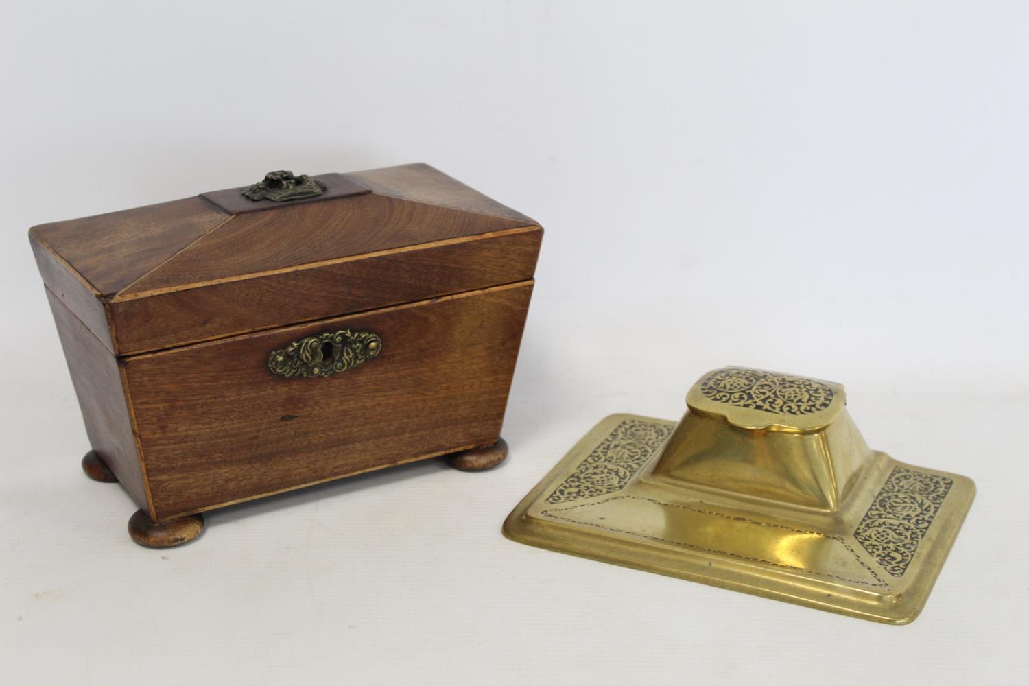 19th Century mahogany tea caddy of sarcophagus form, 21cm wide, unfitted interior, also a brass desk