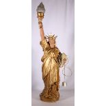 Metal table light in the form of the statue of liberty with opalescent flame shade, 100cm tall