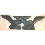 Pair of 19th century cast iron eagle plaques, 95cm wide and 41cm high.