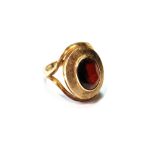 Dress ring with oval garnet on textured band, 9ct gold, 1974, size L.