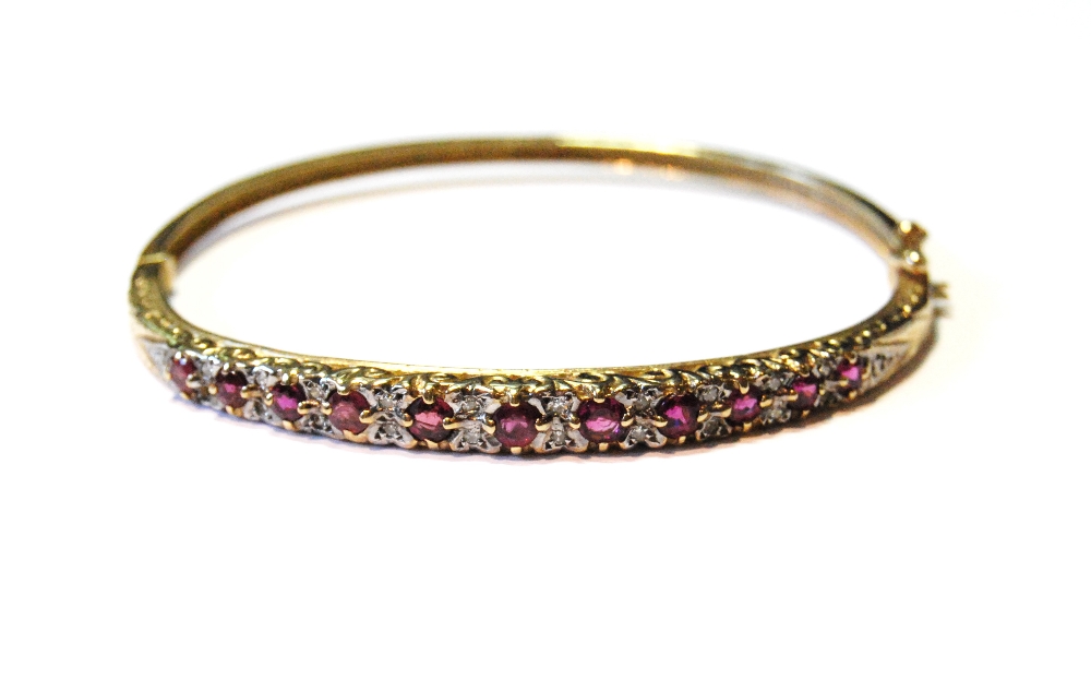 9ct gold hinged bangle with diamonds and rubies, 11.9g.