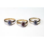 Two diamond and sapphire oval cluster rings and another, with ruby, in 9ct gold, sizes N, O and O½.