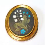 Victorian gold oval brooch with lily of the valley in hardstones, engraved key pattern border,