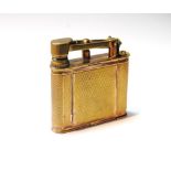 Unusual gilt metal compact modelled as a Dunhill lighter, engine turned, 1928.