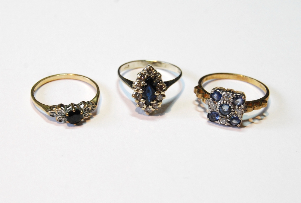 Diamond and sapphire marquise cluster ring, another, pale blue, and a similar smaller ring, all