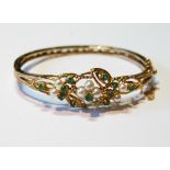 Gold hinged bangle with pearls and emeralds upon openwork, probably 9ct, 16g.