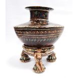 Iznik style pottery vase with floral decoration over brown glaze and raised on tripod base, 20cm