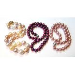 Three coloured pearl necklets of various hues.