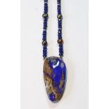 Lapis lazuli and gold bead necklet with matrix lapis pendant.