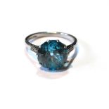 Zircon solitaire ring of aquamarine hue, 11mm, with diamond-set shoulders, 'platinum', size P.