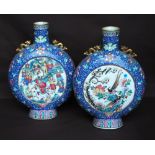 Pair of 19th century Chinese moon flasks, each with gilt dragon shoulders and overall polychrome