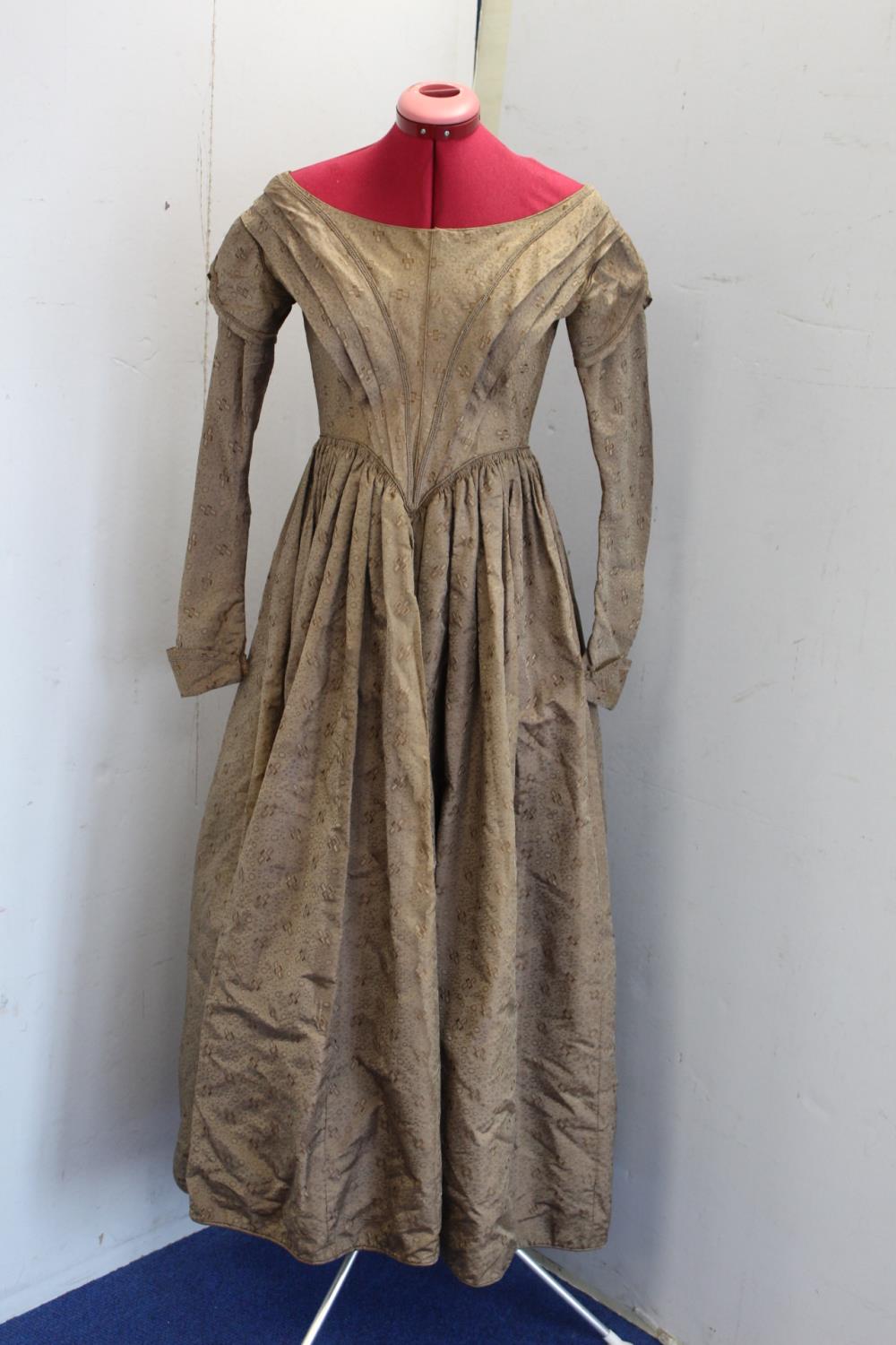 Victorian lady's brown silk damask dress with wide neck, V shaped pleated bodice with slim capped