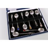 Set of eight contemporary hammered silver coffee spoons set with gem stones to the finials including