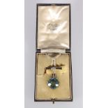 Unhallmarked white metal pendant brooch set with large aquamarine coloured faceted round cut stone