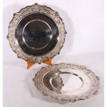 Pair of contemporary silver salvers or tureen stands with piecrust and C scroll border edges, shield