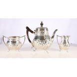 Victorian silver three-piece tea set with repousse gadrooned and floral decoration by Atkin Brothers