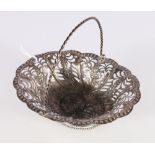 George III silver swing-handled basket with pierced floral design and repouse floral decoration,