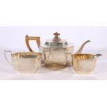 Art Deco silver three-piece tea set with incised wave and pit border by Hamilton and Inches