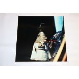 Photograph of a United States Apollo missions rocket with earth in the background, printed on