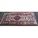 Kurdish rug with central medallion, geometric design over cream ground and cruciform border, 175cm x