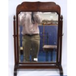 Mahogany dressing mirror, the serpentine pediment over bevelled glass plate on supports mounted by