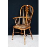 Yew wood Windsor chair, the comb back with pierced central splat, hoop arms, shaped seat, raised