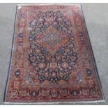 Ushak rug with central floral medallion over blue ground, all over floral design, spandrels and