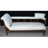 Edwardian mahogany chaise longue with cushioned top rail over elaborate supports, cushioned left arm