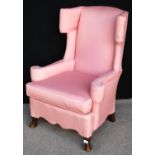 Wing back armchair, the scroll wings over cushioned back, loose cushioned seat, shaped apron, raised