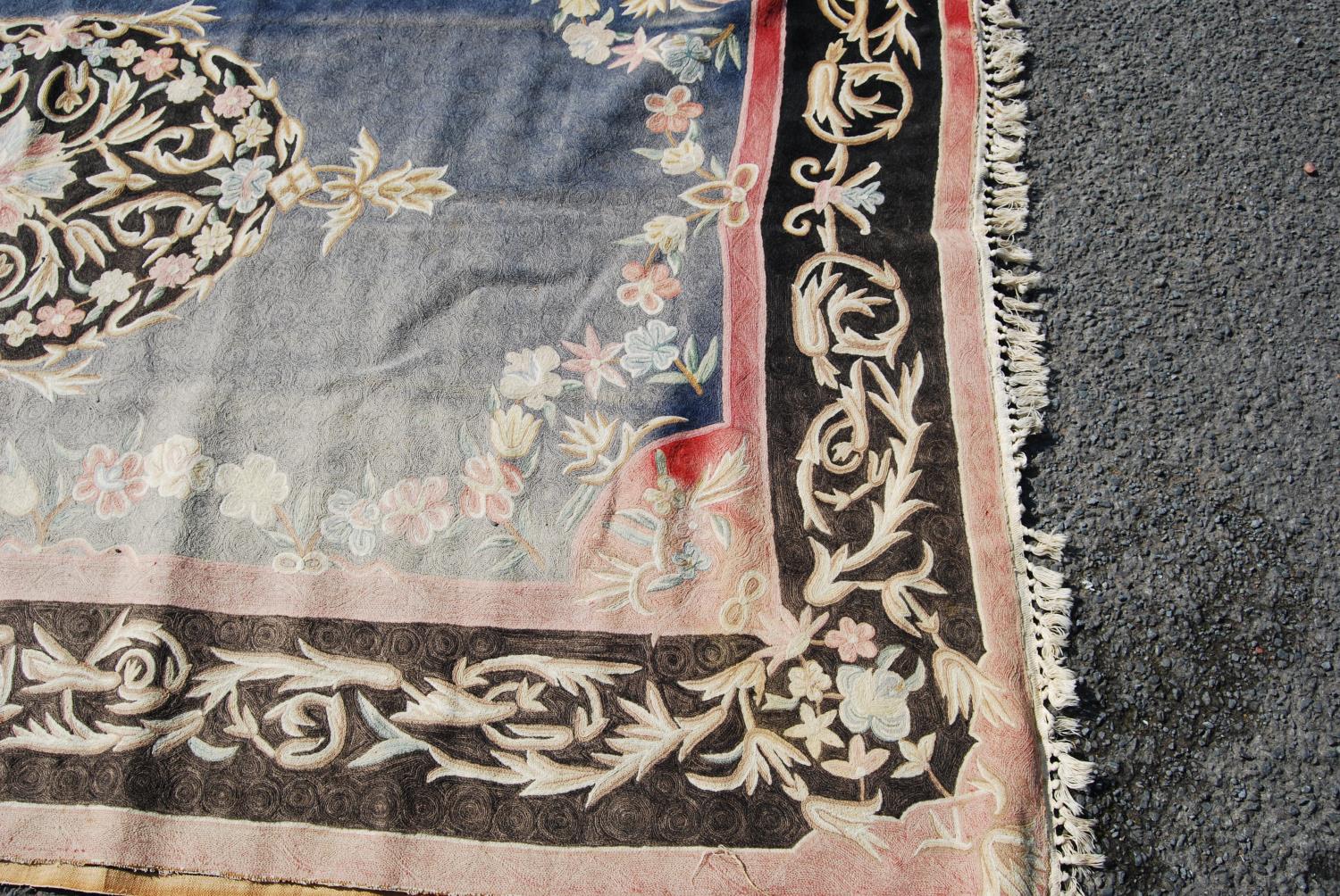 Eastern rug with central floral lozenge over faded blue ground, black and pink floral border, - Image 4 of 7