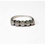 Diamond five-stone ring with separate claw-set brilliants, the largest approximately .2ct, 'plat',