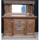 Large late Victorian oak sideboard, the projected moulded cornice over carved frieze, mirrored