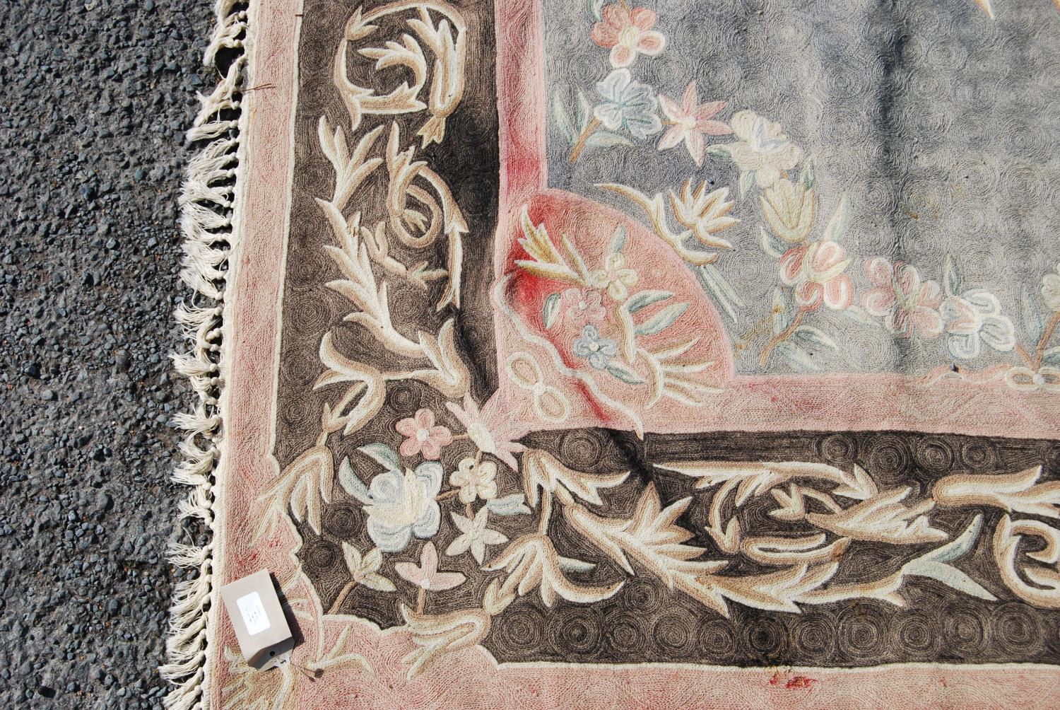 Eastern rug with central floral lozenge over faded blue ground, black and pink floral border, - Image 3 of 7