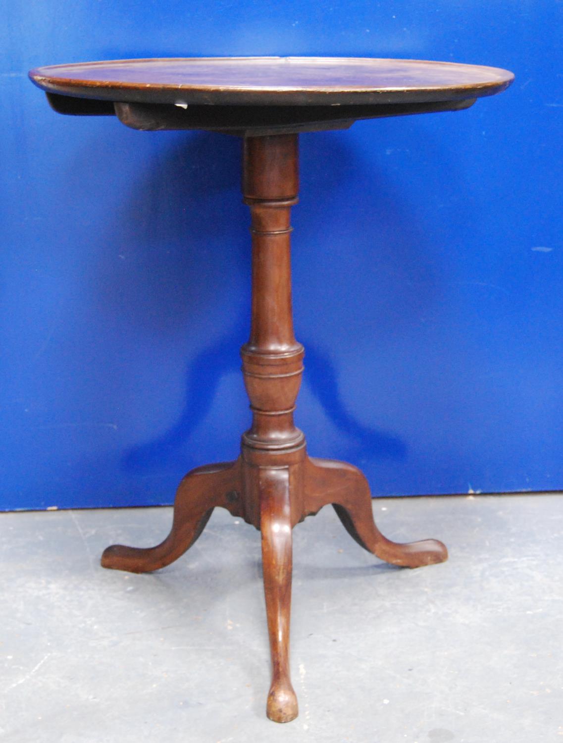 19th century mahogany tilt top table, the circular top with rim raised on urn turned column,