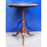 19th century mahogany tilt top table, the circular top with rim raised on urn turned column,