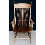 Oak comb back chair, the arched top rail over open baluster arms, shaped seat, raised on splayed