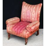 Unusual Victorian armchair with stuff-over frame, raised on baluster turned legs terminating in