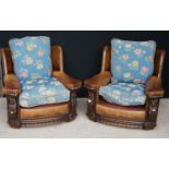 Pair of leather armchairs, each with loose cushion seats and frieze carved panels, 88cm wide, 77cm
